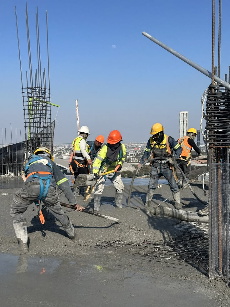Construction workers pouring concrete for a commercial building project in Kernersville, NC